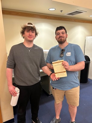 two men holding a copy of a book